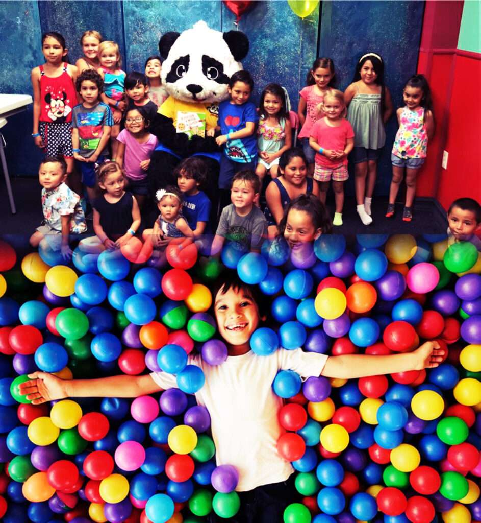 Juju the panda with a group of kids having a birthday party at LOL Kids Club