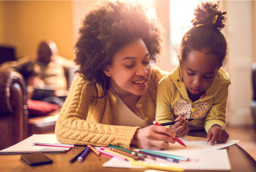 parent teaching child how to write