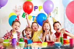 kids birthday party with balloons cake pizza